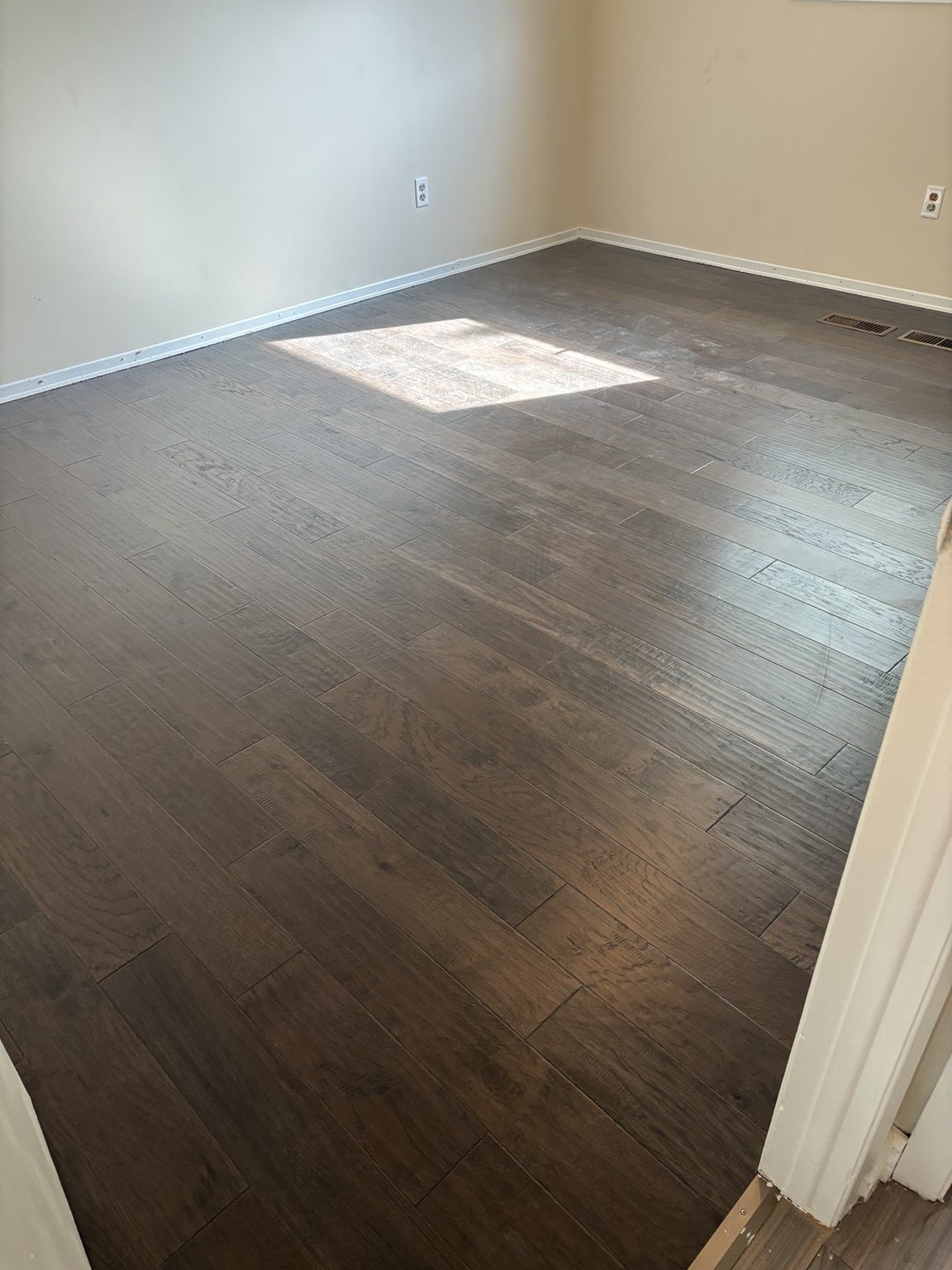Dark finished flooring installation in bedroom or living area