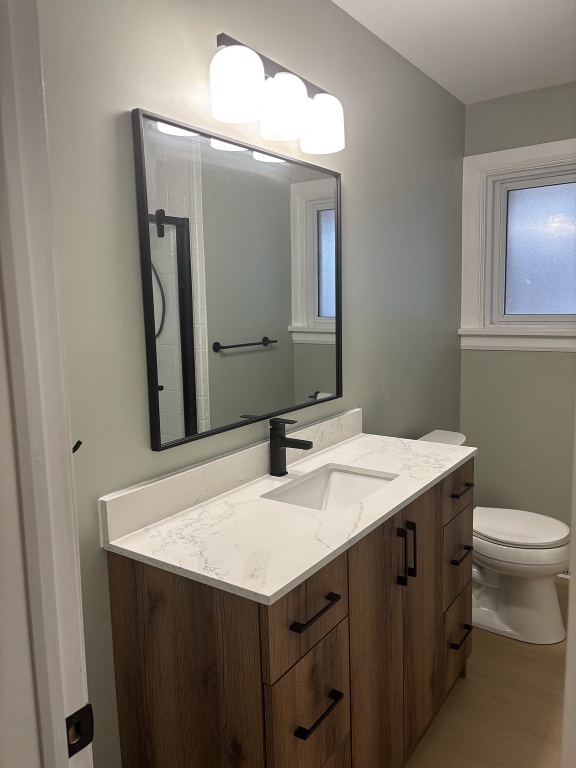 Finished bathroom vanity with black fixtures