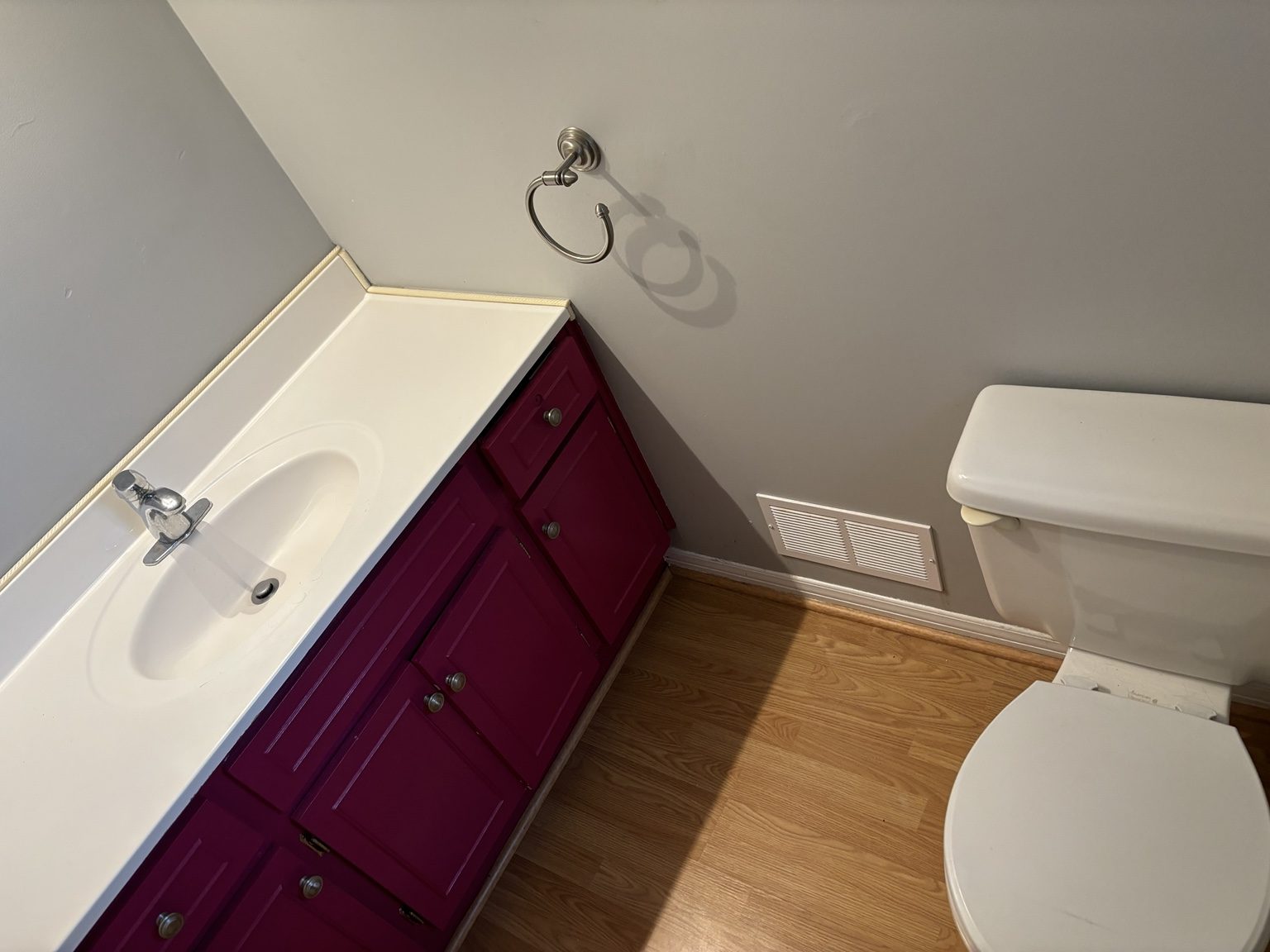 Bathroom before vanity update with bright cabinet